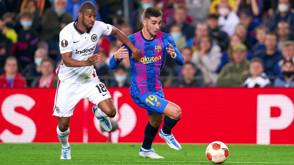 Ferran Torres of FC Barcelona competes for the ball with Almamy Toure of Eintracht Frankfurt