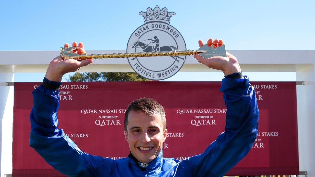 William Buick: celebrates by displaying his golden whip trophy after winning the Nassau
