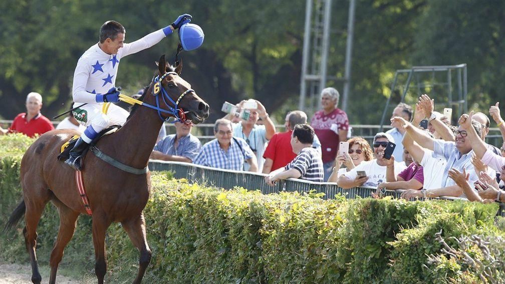 Crowd pleaser: Jorge Ricardo salutes racegoers at San Isidro after breaking the world record for career victories on Hope Glory on Wednesday's card at the Buenos Aires venue