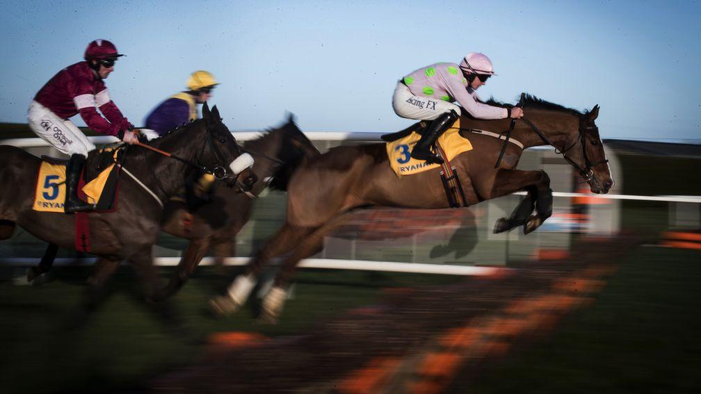 Faugheen (middle) clears a hurdle in the Grade 1 2m Ryanair Hurdle, although is eventually pulled up by Paul Townend before entering the home straight on the ﬁnal circuit