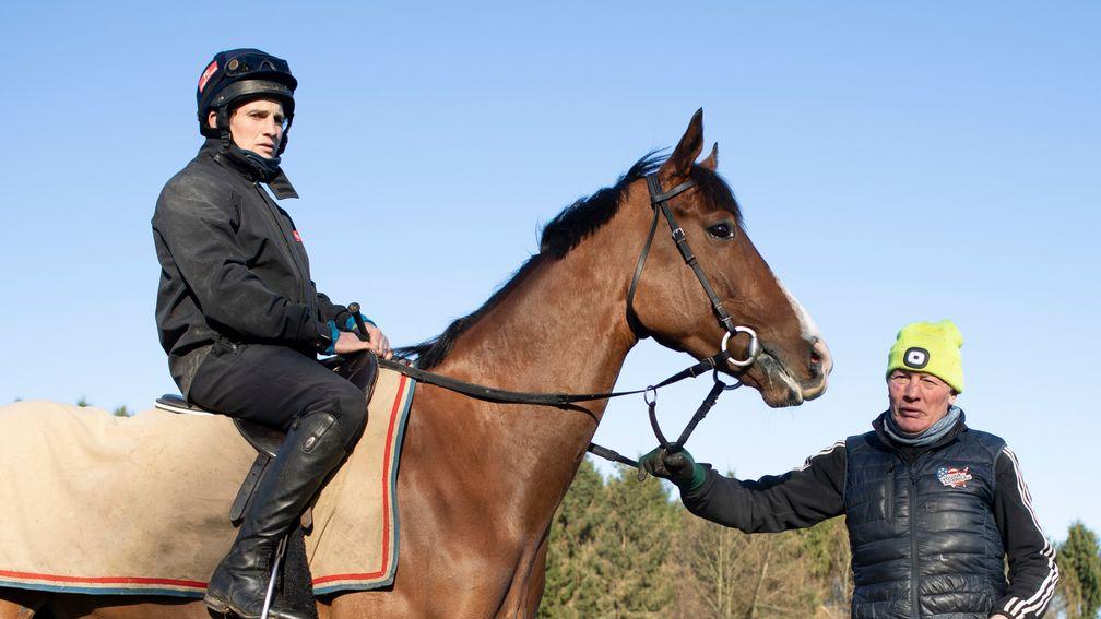 Goshen and jockey Jamie Moore stand with trainer Gary Moore on the gallops at Cisswood Racing Stables in West Sussex 26.2.21Pic: Edward Whitaker
