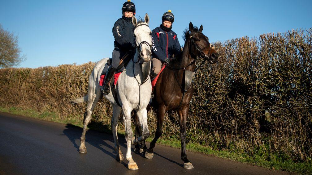 Scott Marshall (right) riding Clan Des Obeaux alongside fellow Grade 1 winning chaser Politologue (Kate McCormack) at Manor Farm Stables