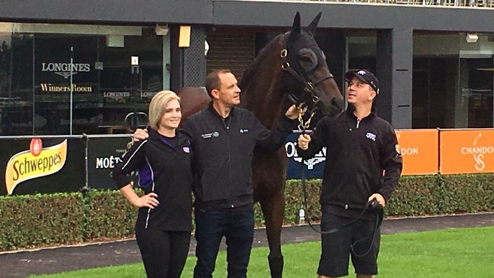 Winx appears in front of camera crews at Rosehill on Sunday alongside trainer Chris Waller and her strappers Umut Odemislioglu and Candice Persijn