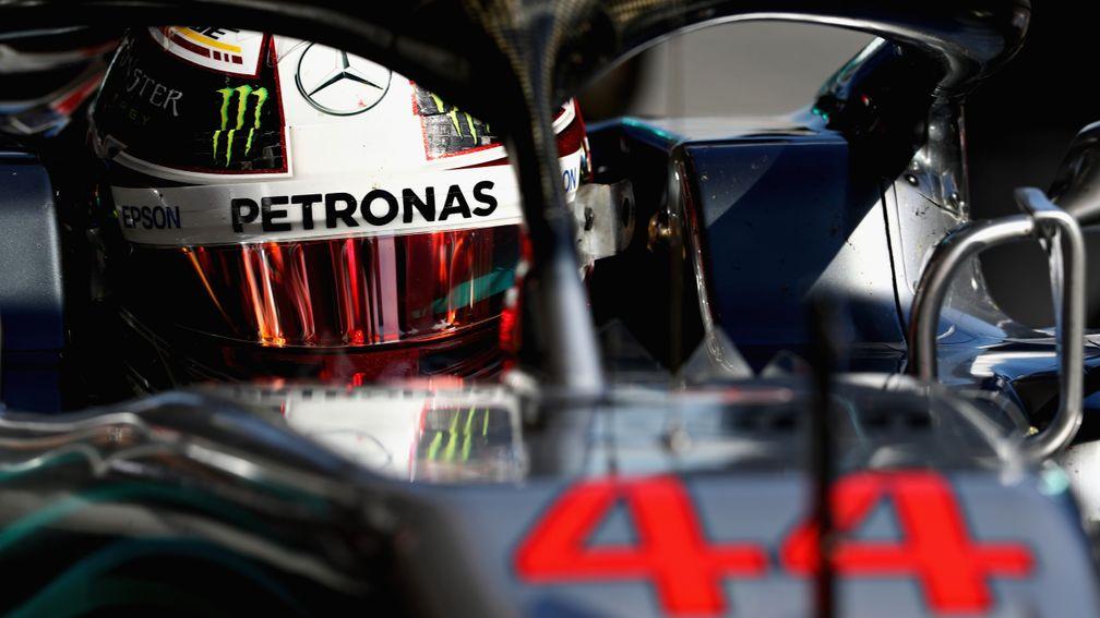 Lewis Hamilton peers out from his Mercedes during pre-season testing