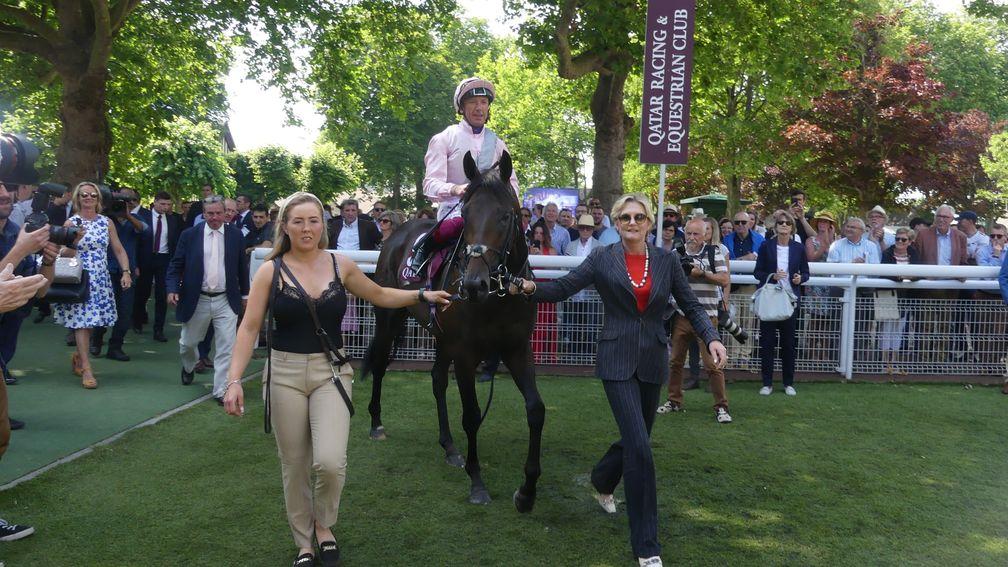 Too Darn Hot returns to the winner's enclosure after victory in the Prix Jean Prat