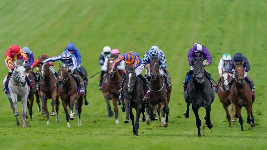 Ryan Moore riding Auguste Rodin (blue/orange) to win the Betfred Derby