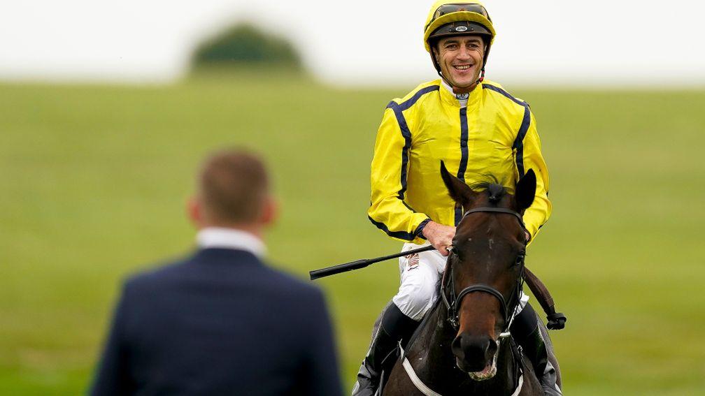 Christophe Soumillon sports a big grin as he heads back to the winner's enclosure following his victory on Perfect Power