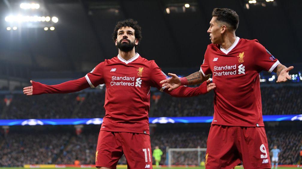 Mohamed Salah and Roberto Firmino celebrate after opening the scoring in the quarter-final against Manchester City