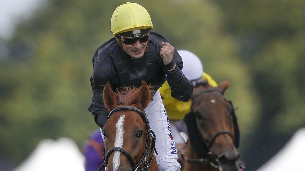 Andrea Atzeni punches the air in delight as Stradivarius crosses the line