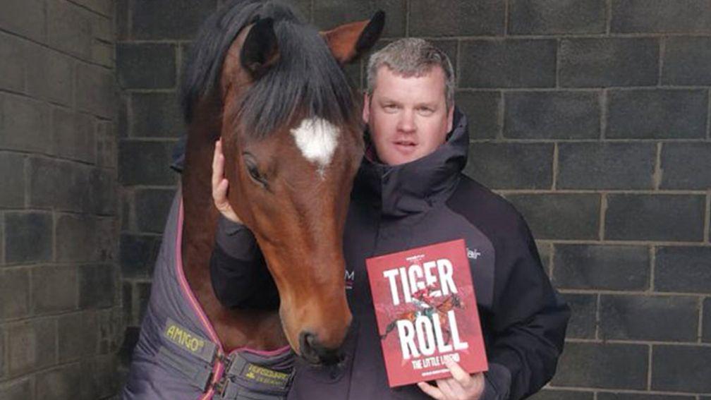 Aintree hero Tiger Roll and Gordon Elliott with their copy of Tiger Roll: The Little Legend