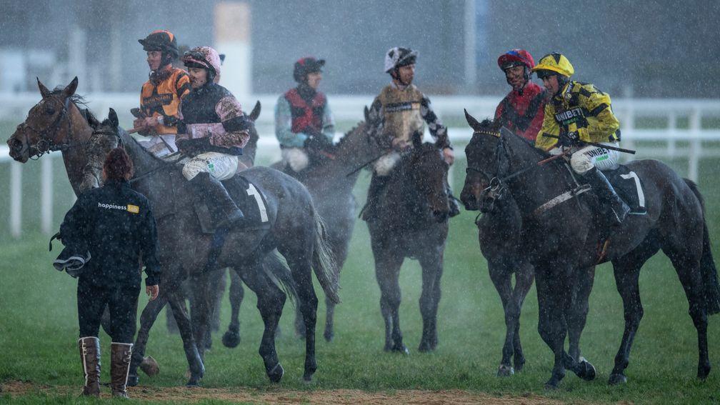 Runners return in the rain following the maiden hurdle at Ascot on Friday