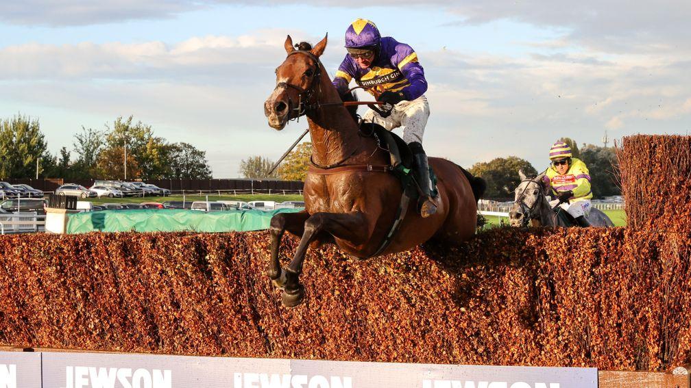 Corach Rambler soars over a fence en route to victory at Aintree