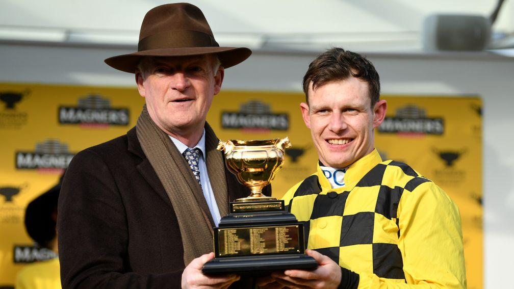 Willie Mullins and Paul Townend get their hands on the Magners Cheltenham Gold Cup trophy after the victory of Al Boum Photo