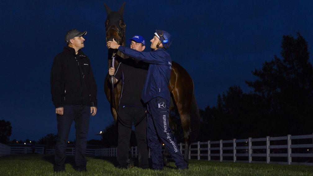 Trainer Chris Waller (left), Jockey Hugh Bowman (right) and strapper Umut Odemislioglu pose with Winx after a workout at Flemington