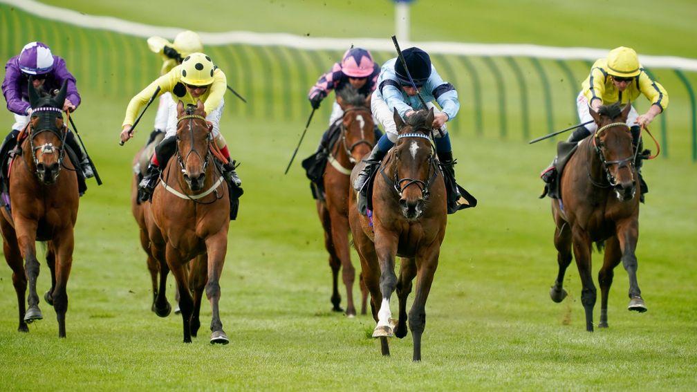 NEWMARKET, ENGLAND - APRIL 12: William Buick riding Cachet (light blue) win The Lanwades Stud Nell Gwyn Stakes at Newmarket Racecourse on April 12, 2022 in Newmarket, England. (Photo by Alan Crowhurst/Getty Images)