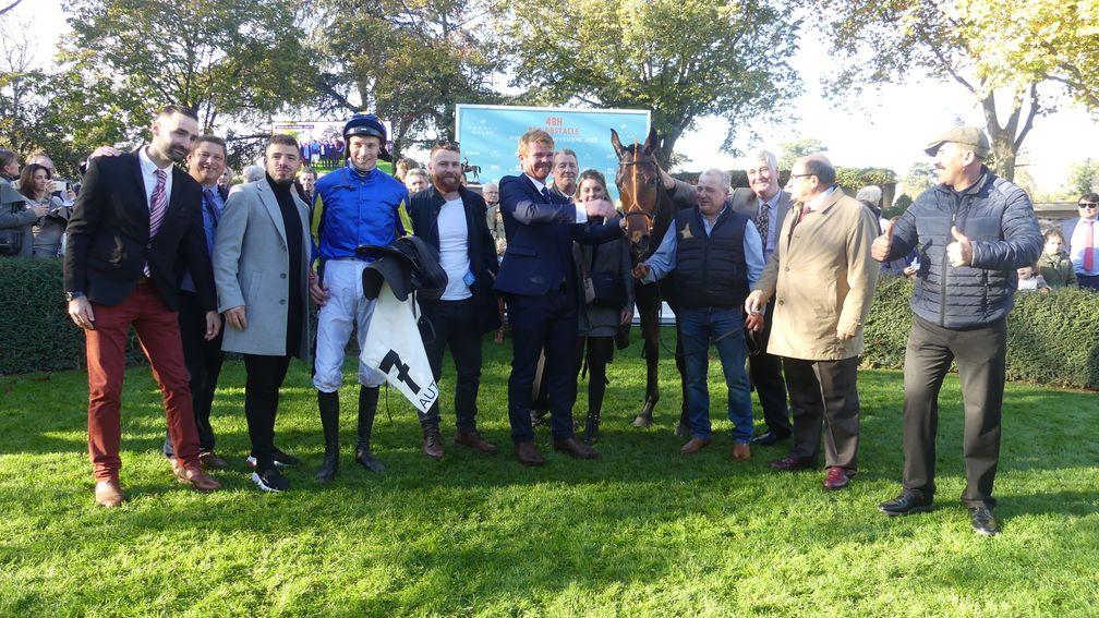 St Donats flanked by jockey James Reveley and his father James, as well as trainer Hugo Merienne (blue suit)