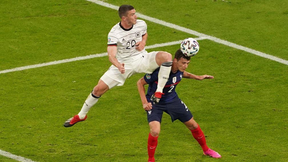 Benjamin Pavard was knocked unconscious after this clash with Robin Gosesns