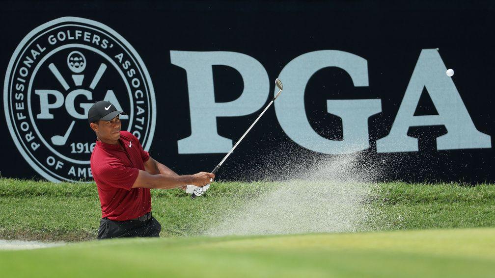 Tiger Woods plays a shot from a greenside bunker at the 2018 US PGA Championship