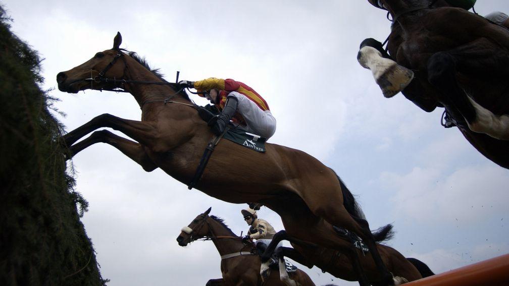 Tiutchev with Tony McCoy jumps a ditch on their to winning the Martell Cup at Aintree 1st April 2004 Mirrorpix