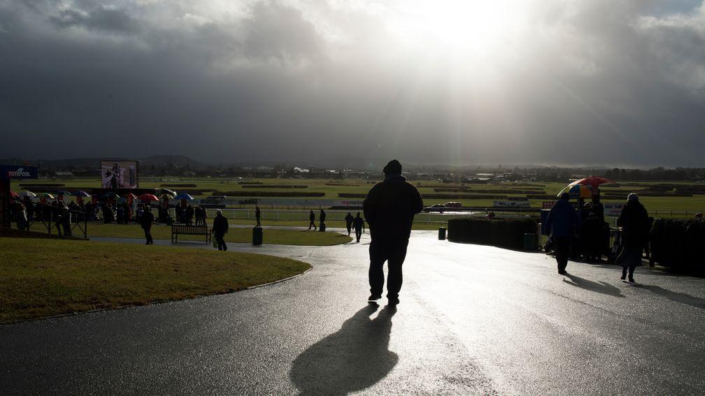 A racegoer walks down to the betting ring at Hereford