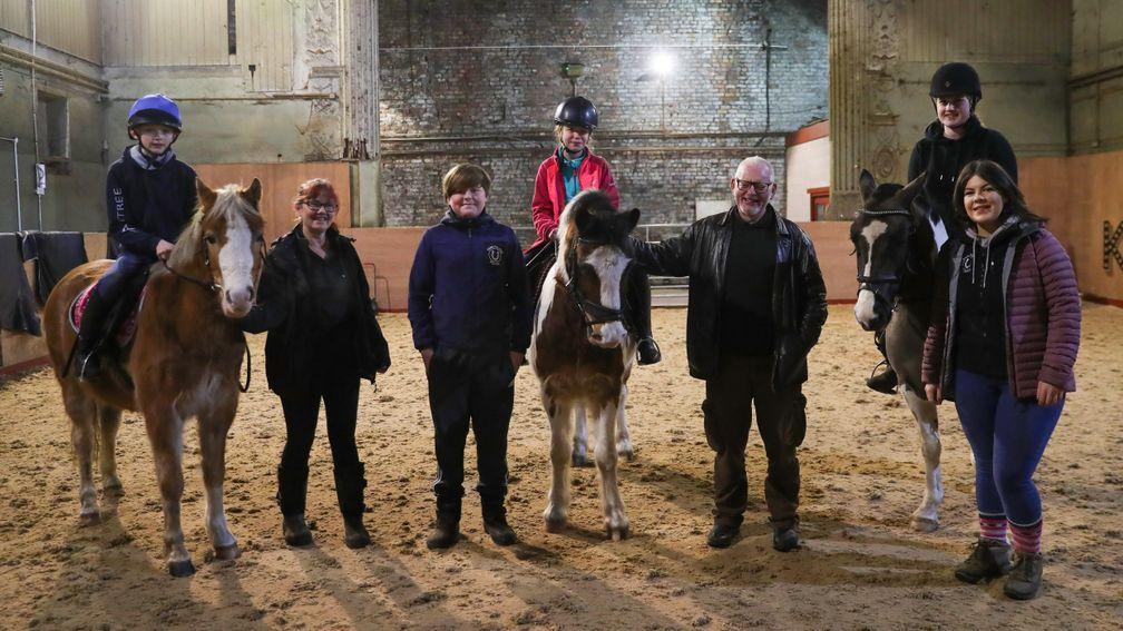Staff and pupils are all smiles in the riding arena