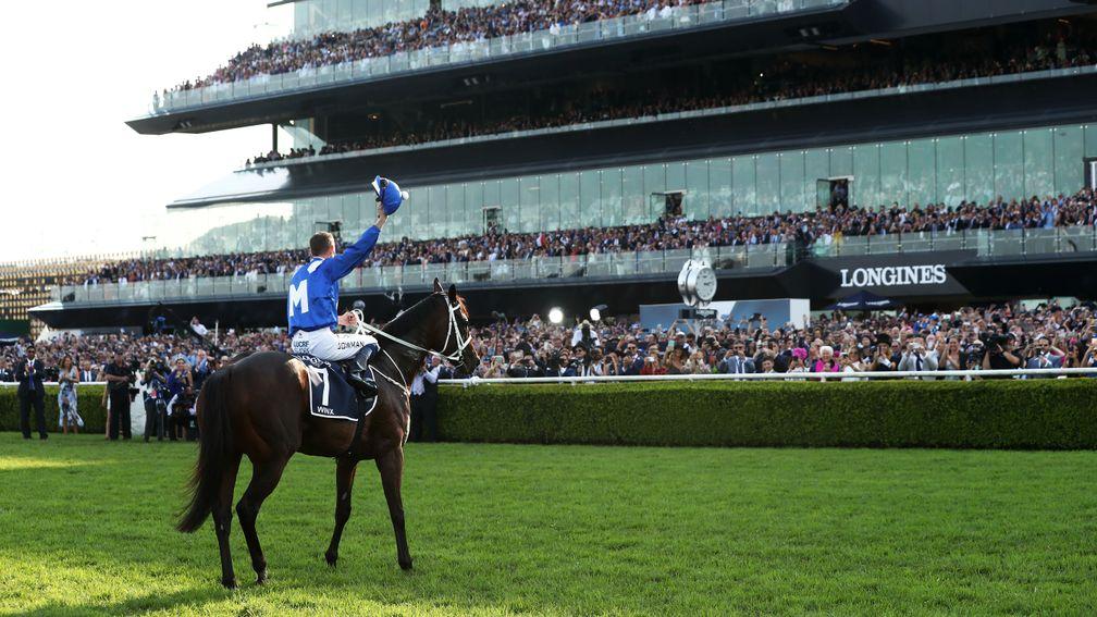 Hugh Bowman salutes the crowd on Winx after her farewell success