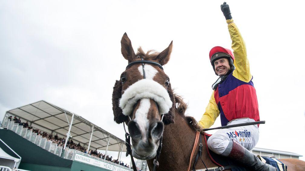 Richard Johnson has his arm aloft in triumph after winning the Gold Cup on Native River