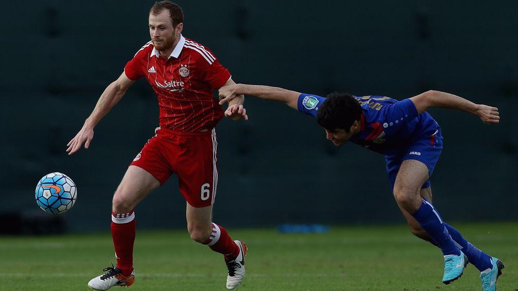Mark Reynolds (left) of Aberdeen in action during a friendly match against Bunyodkor