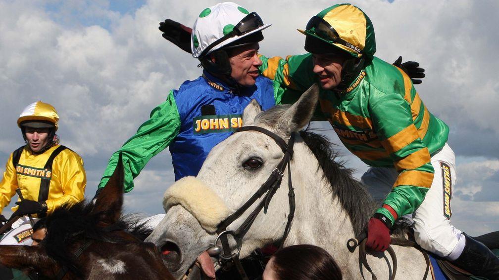 Timmy Murphy (left) is congratulated by Paul Carberry after winning the Grand National on Comply Or Die