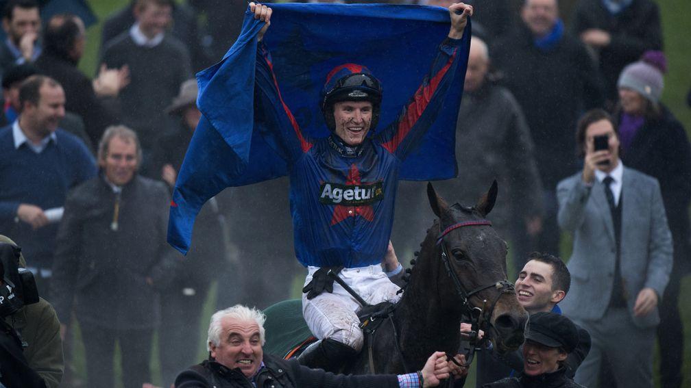 Flying the flag: Tom Bellamy salutes the crowd as Splash Of Ginge is led into the winner's enclosure by owner John Neild
