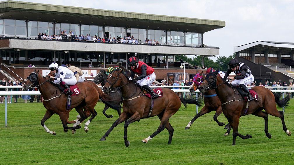 NEWTON-LE-WILLOWS, ENGLAND - JULY 01: Dapper Man and Saffie Osborne (left) coming home to win the Haydock Apprentice Training Series Handicap at Haydock Park Racecourse on July 1, 2021 in Newton-le-Willows, England. (Photo by Martin Rickett - Pool/Getty I
