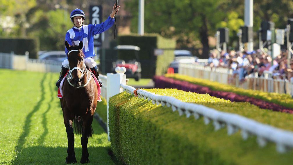 Hugh Bowman laps up the applause following Winx's victory in the Colgate Optic White