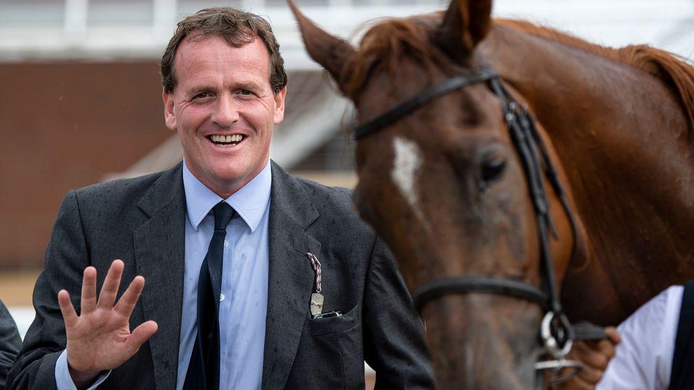 First five: Richard Hannon celebrates his first five-timer on one card after Ritchie Valens wins the last at Newbury on Tuesday