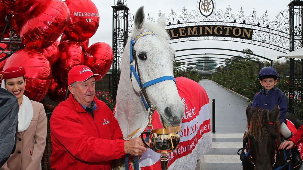 MELBOURNE, AUSTRALIA - JUNE 13:  1992 Melbourne Cup winning horse Subzero, held by Clerk of the Course, Graham Salisbury licks the 2013 Emirates Melbourne Cup trophy at the VRC's 2013 Emirates Melbourne Cup Tour Destination Launch on June 13, 2013 in Melb