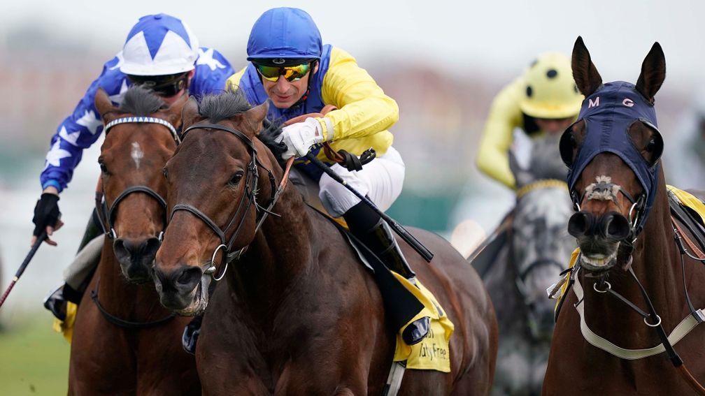 Marmelo and Gerald Mosse (blue cap) run on strongly to win the John Porter Stakes at Newbury