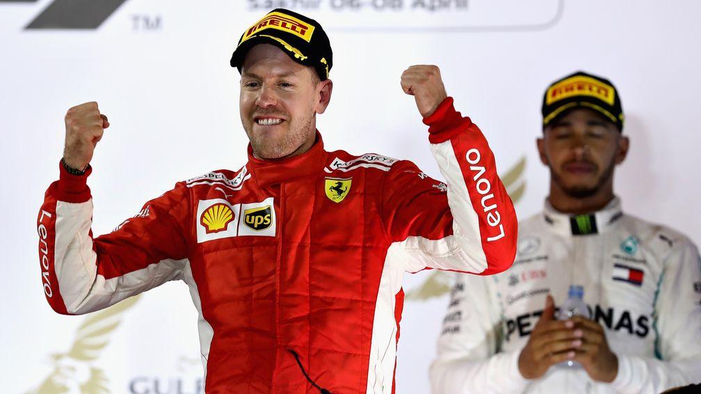 Sebastian Vettel celebrates his Bahrain Grand Prix win as Lewis Hamilton looks on