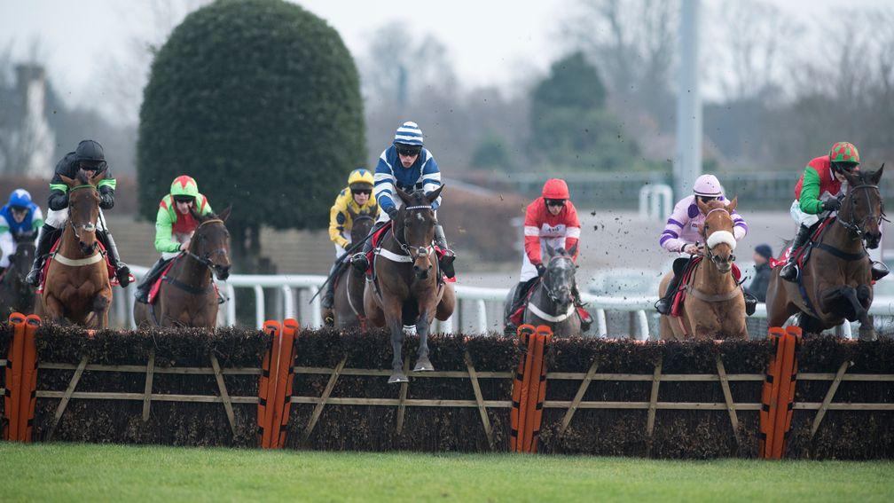 William Henry (centre, navy and white) produces a huge leap at the last before going on to win the Lanzarote Handicap Hurdle