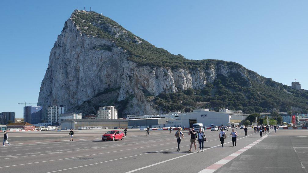 Commuters stroll across the runway at Gibraltar International Airport