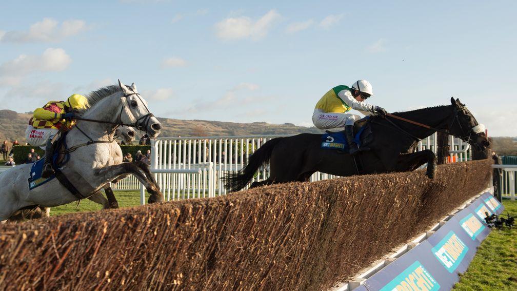 Many Clouds leads Dynaste over the final fence on his way to victory in the 2015 BetBright Cup Chase at Cheltenham