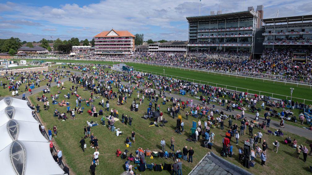 Racegoers gather ahead of the opening race of the Ebor meetingYork 17.8.22 Pic: Edward Whitaker