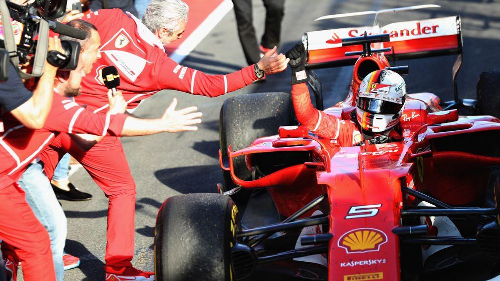 Sebastian Vettel is welcomed back to the pitlane after ending Ferrari’s 28-race losing run in the Australian Grand Prix