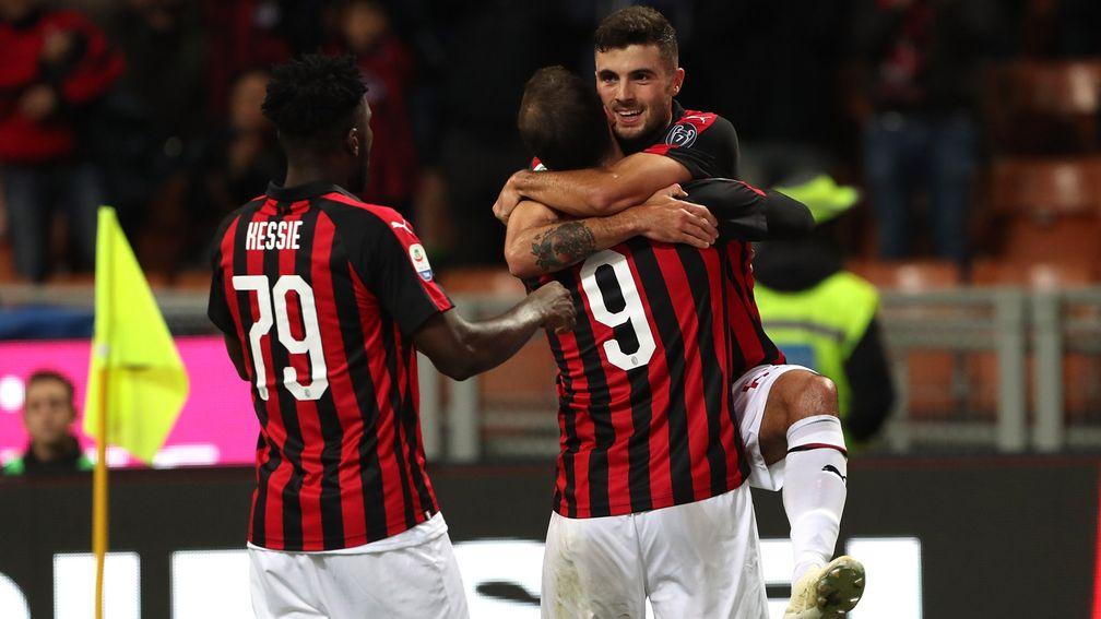 Patrick Cutrone (right) of Milan celebrates with teammates