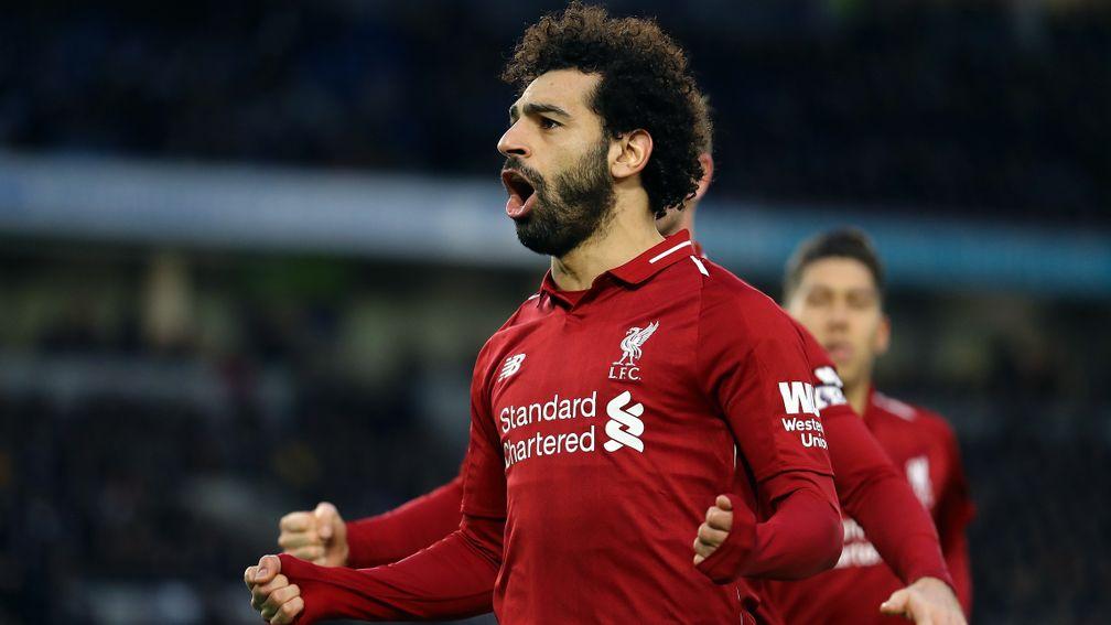 Mohamed Salah celebrates the penalty that gave Liverpool a vital win at Brighton