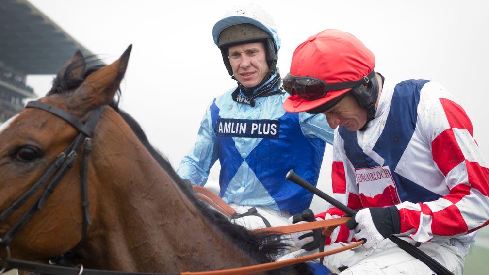 Far from euphoric in victory, Johnson is quick to console a devastated Daryl Jacob after he and Fingal Bay narrowly denied Jacob on Southfield Theatre in the 2014 Pertemps Final