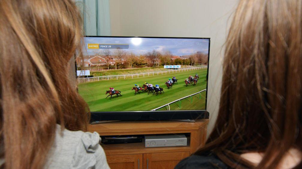 Two children watch the 2020 Virtual Grand National