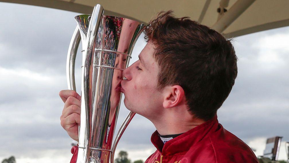 Oisin Murphy Kisses the trophy after winning the Juddmonte International Stakes