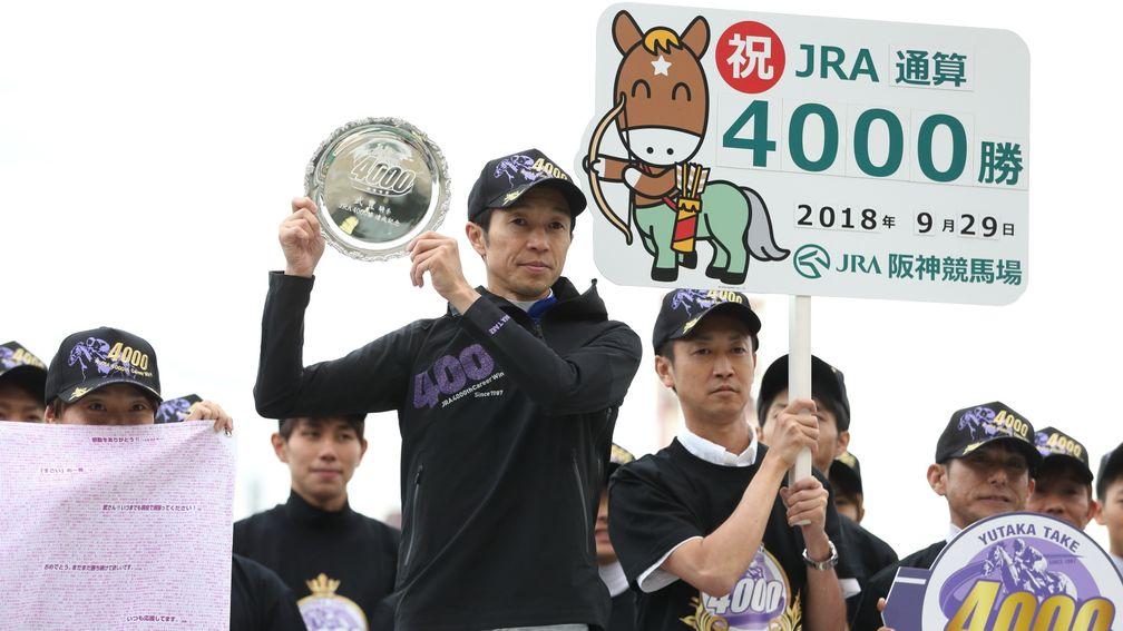 Yutaka Take celebrating after passing 4,000 career JRA victories at Hanshin in September 2018