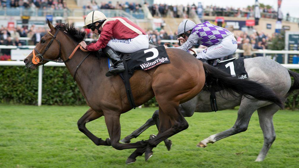 Heartache (maroon) pricks her ears passing the winning post as she lands the Flying Childers Stakes