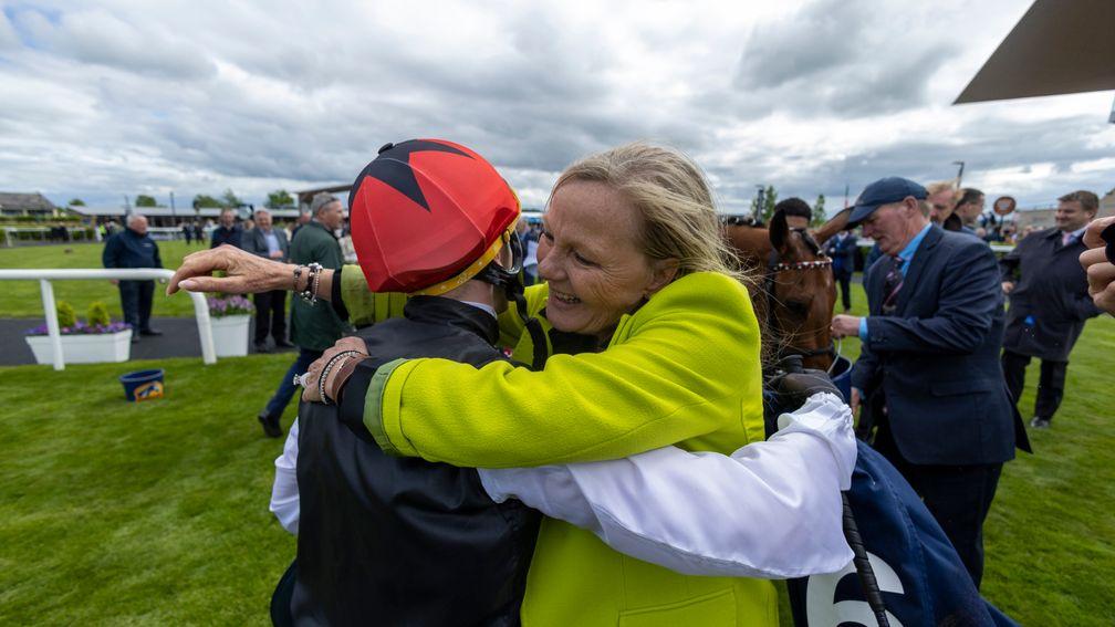 Eva-Maria Bucher hugs Chris Hayes after victory in the Irish 1,000 Guineas for Homeless Songs