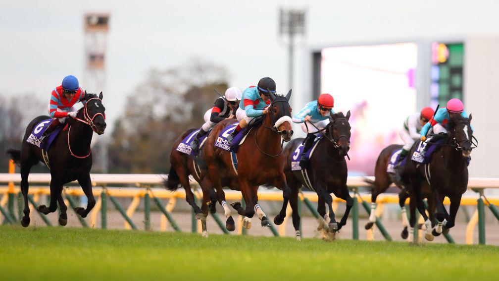 Almond Eye (black cap) sprints to success ahead of Contrail and Daring Tact in the Japan Cup at Tokyo